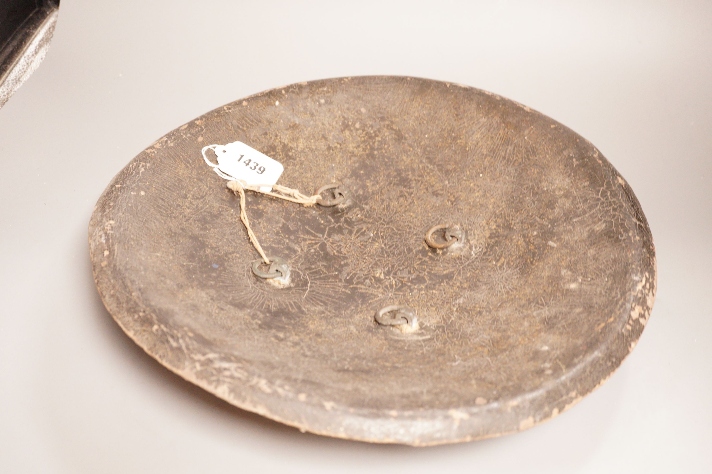 A 19th century Indo-Persian animal hide dahl shield, 41cm diameter, and an African rhino hide shield